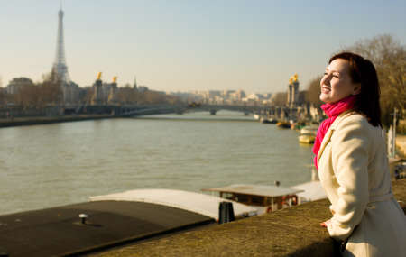 Happy beautiful woman in Paris on the Seine embankmentの写真素材