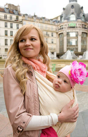 Traveling with baby. Beautiful young mother with her baby daughter in Parisの写真素材