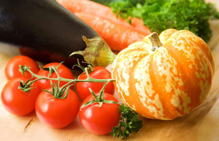 Vegetable background. Fresh tasty vegetables on the wooden tableの写真素材
