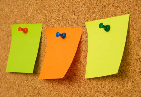 Multicolored paper notes on cork boardの写真素材