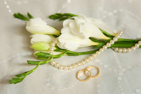 Wedding card. Two golden rings with bridal veil and flowersの写真素材