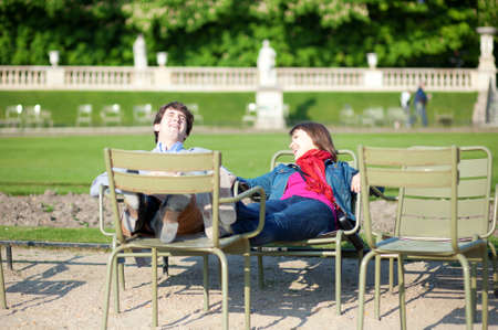 Young French couple relaxing in the Luxembourg Garden of Parisの写真素材