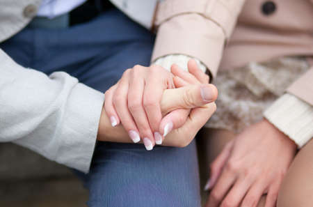 Couple having a date, holding each others handsの写真素材
