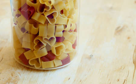 Heart-shaped pasta in a glass jarの写真素材