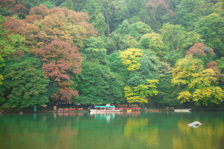 Boats on Katsura river at fall in Arashiyama, Japan
