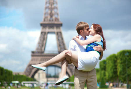Man carrying his girlfriend in his arms in Parisの写真素材