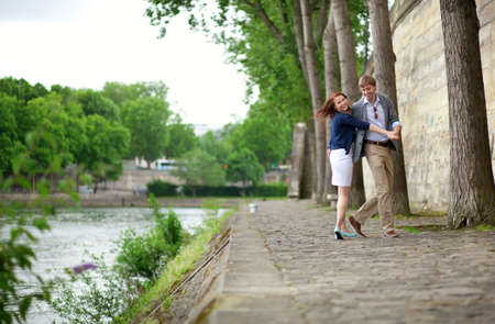 Happy couple is dancing on the Seine embankment in Parisの写真素材