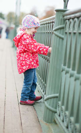 Cheerful little girl close to the grillの写真素材