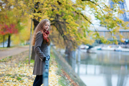 Beautiful blond girl on Swan island near the Eiffel tower in Parisの写真素材