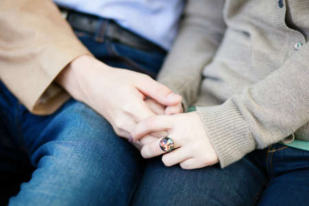 Loving couple holding hands during a dateの写真素材