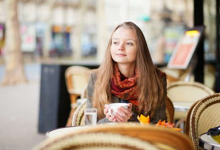 Pensive girl in a Parisian outdoor cafeの写真素材
