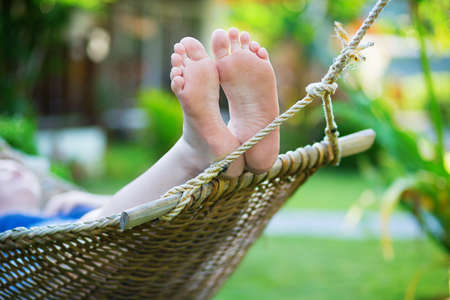 Woman relaxing in hammock on a tropical resortの写真素材