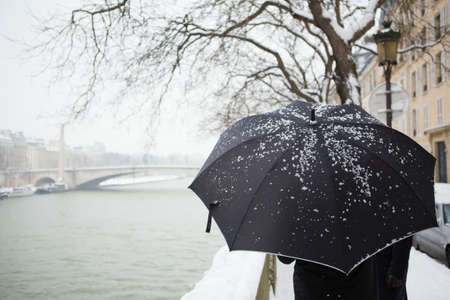 People walking on a Parisian street under snowの写真素材