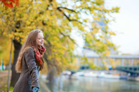Beautiful young girl enjoying autumn day in Parisの写真素材