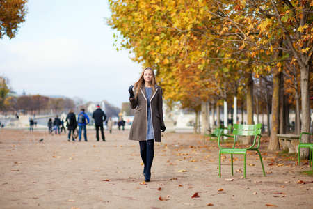 Girl walking in the Tuilleries garden on a fall dayの写真素材