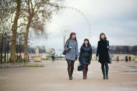 Three girls walking in the Tuileries gardenの写真素材