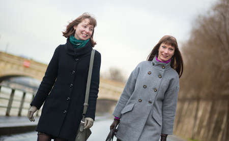 Two cheerful friends walking togetherの写真素材