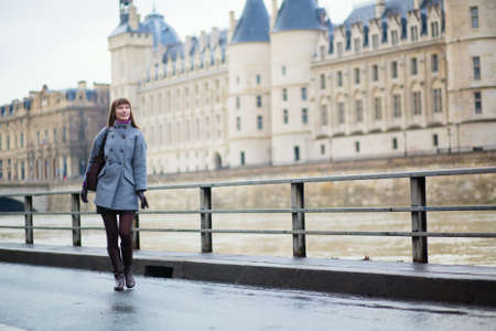 Young girl on the embankment in Parisの写真素材