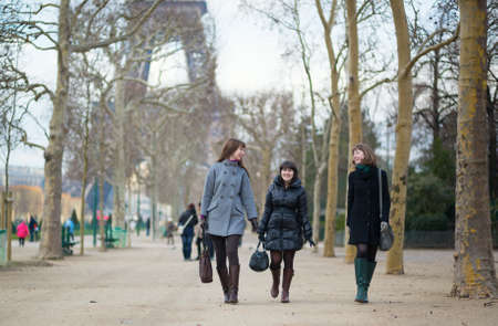 Three cheerful friends walking together in Parisの写真素材