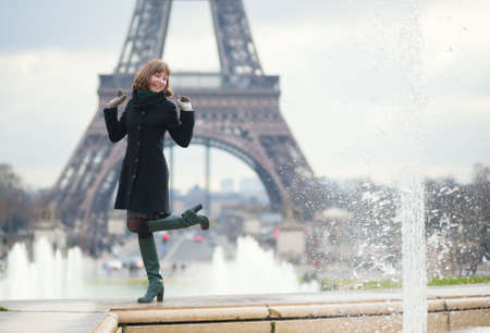 Cheerful girl near the Eiffel tower in Parisの写真素材