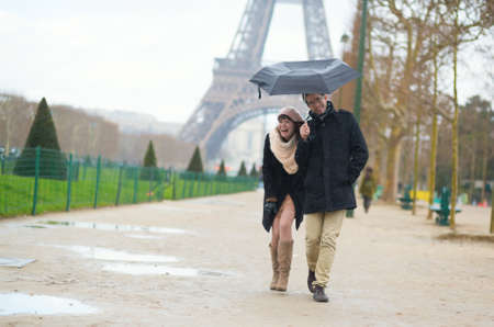 Romantic couple under the rain in Parisの写真素材