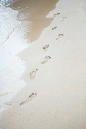 Footsteps on a perfect white sand beachの写真素材