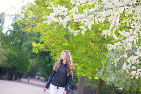 Beautiful girl under blooming treeの写真素材