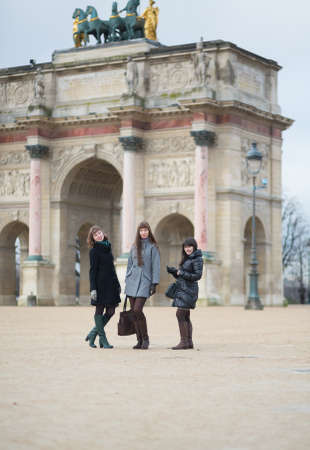 Three joyful girls together in Parisの写真素材