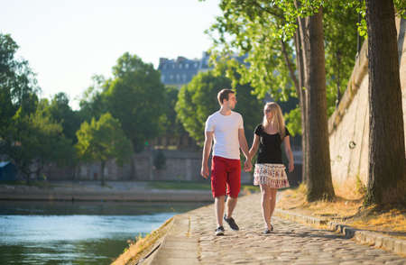 Romantic couple walking near the Seine