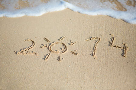 2014 written in sand on beach textureの写真素材