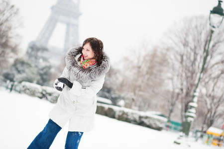 Girl playing snowball in Paris on a winter dayの写真素材