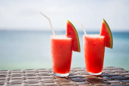 Two fresh watermelon juices on a tropical beachの写真素材
