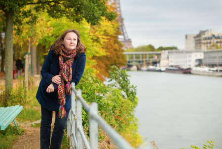Young woman on a bright fall day in Parisの写真素材