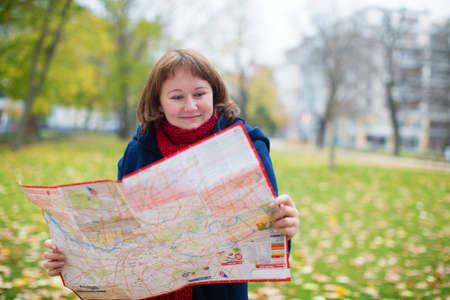 Girl with a map on the street