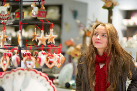 Girl selecting decoration on a Christmas marketの写真素材