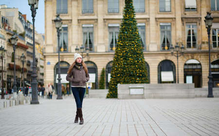 Girl on a Parisian street decorated for Christmasの写真素材