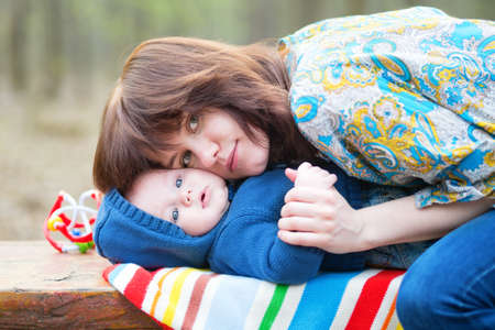 Young mother hugging tenderly her 4 month old sonの写真素材