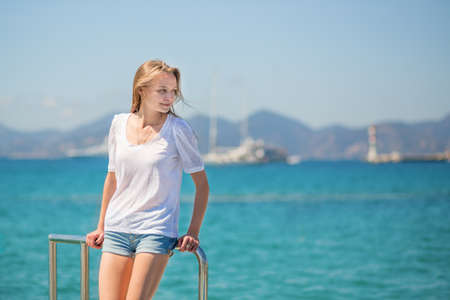 Beautiful young girl on yacht in the seaの写真素材