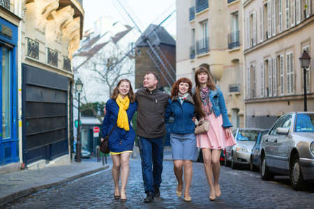 Four friends walking in Paris togetherの写真素材