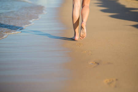 Young woman walking or running on the beachの写真素材