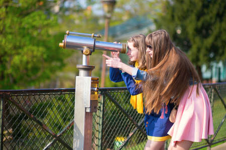Girls using telescope for sightseeing in Parisの写真素材
