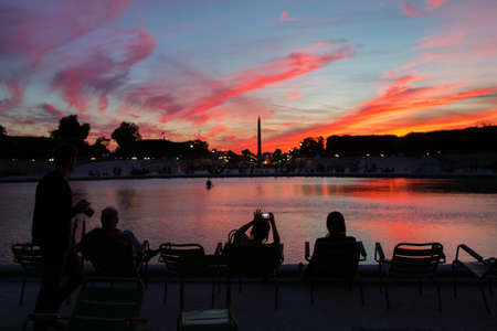 People enjoying beautiful sunset in the Tuileries park of Parisの写真素材