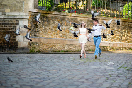 Happy just married couple jumping on the streetの写真素材