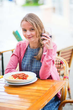 Young French woman having lunch in an outdoor cafe of Cannesの写真素材
