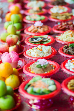 Food plates near the Chinese temple in Singapore, prepared for the believersの写真素材