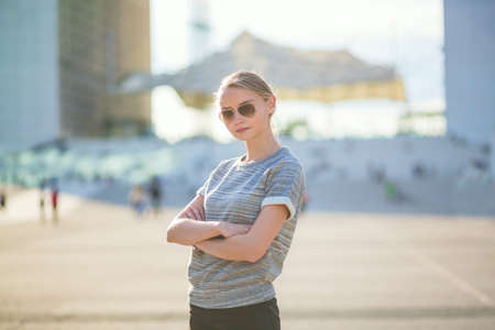 Young confident woman in business district of Parisの写真素材