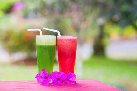 Fresh organic watermelon and cucumber juices with flowersの写真素材
