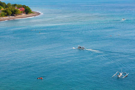 People snorkeling in turquoise water on the Eastern coast of Baliの写真素材