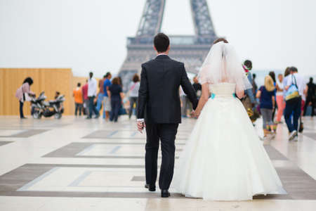 Just married couple walking to the Eiffel tower