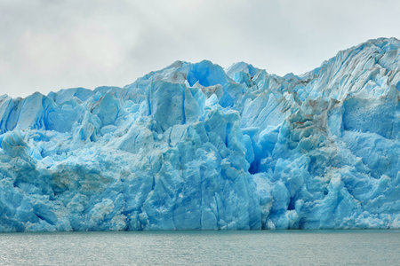 Blue icebergs and snowy mountains at Grey Glacier in Torres del Paine National Park, Patagonia, Chileの写真素材